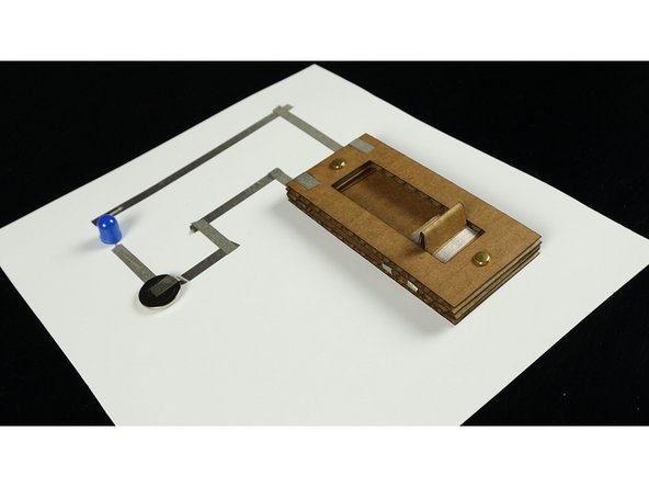 We built a simple circuit using an LED, a battery, and some Maker Tape, and then connected our switch into it. It worked great!