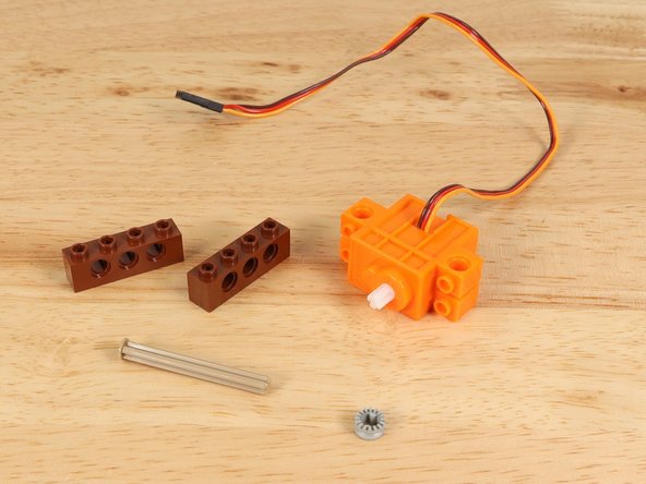 We'll start by adding some "feet" to the servo so we can attach it to the baseplate.