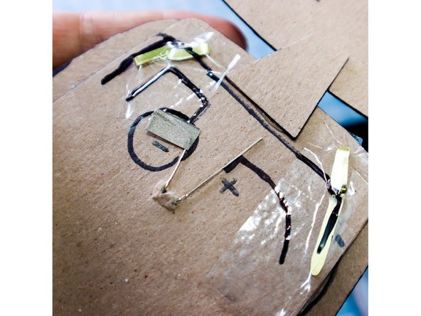 Add clear or electrical tape on top of the paper fasteners to prevent them from shorting the circuit.