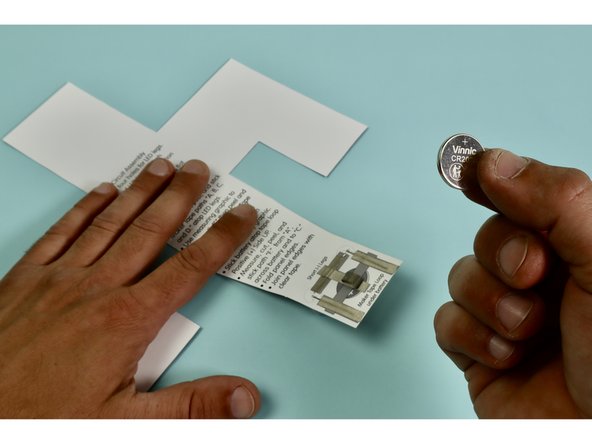 Install battery by pressing it into place atop the tape loop Positive (+) Side UP.