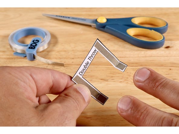 Measure, cut, peel, and stick Maker Tape paths where shown on Side One of the switch lever.