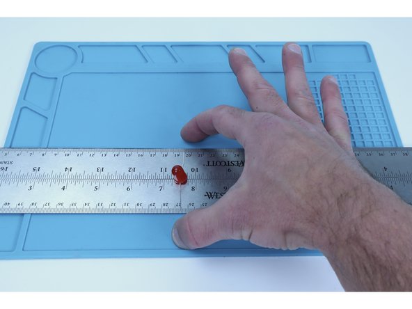 Notice that when bent outward in opposite directions, the span of any single LEDs two legs is about the width of two rulers side-by-side. We will use two rulers to help us create pathways that the LEDs can sit between and still contact on both sides.