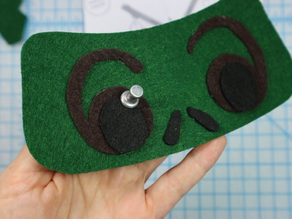 Use a push pin to make two holes for the LED's legs. When the push pin is inside the felt, rotate it around a bit to make the hole larger and easier to see.