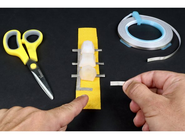 Cut another small piece of Maker Tape that is about half the width of the felt and stick it where shown in photo 2. If done correctly, it should contact the longer path you just laid down and stop where shown.