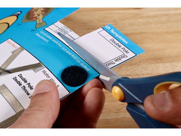 Cut and remove the U-shaped switch lever template labeled &quot;Double Pole Double Throw Lever Switch&quot; from the switch template bank located in the upper right hand corner of the Flat Fish project poster.