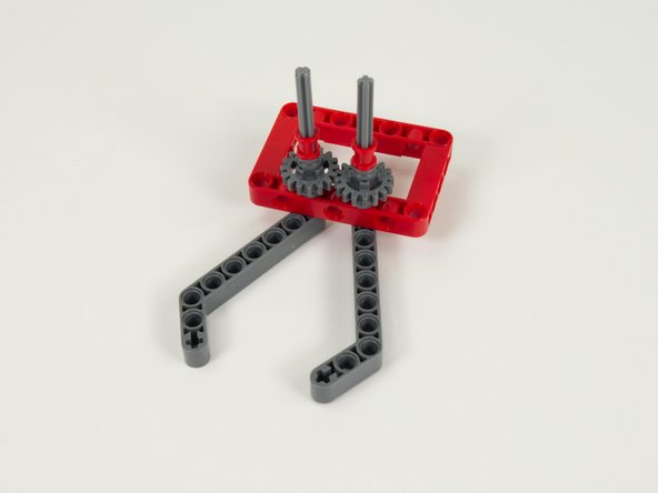 Press two red (full size) bushings down the axles so they are pressing against the half bushing added in the previous step.