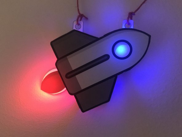 Bend the tabbed pieces on the top part of the rocket so they can go under/behind the bottom part of the rocket.