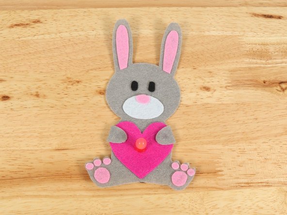 If you are using Elmers or Tacky glue, you will need to use something to hold the paws in place until it dries. Binder clips work well for this.