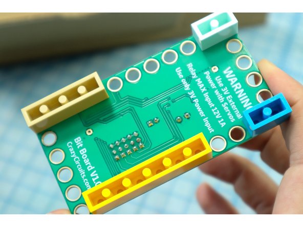 Place LEGO on the bottom of the board, making sure to cover pins 9-14 and ground (-).