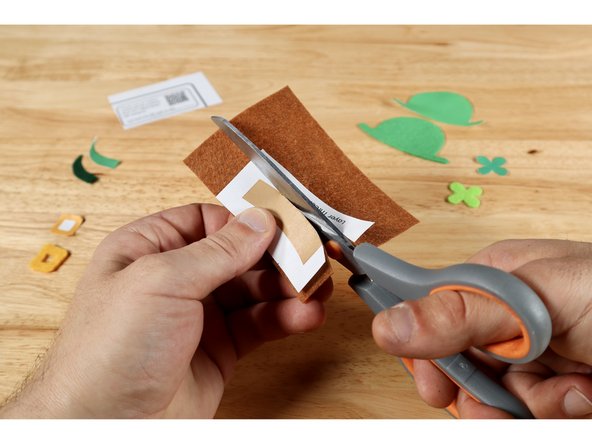 Lay each template piece atop the felt. Pinch both together and cut through both. You CAN also cut each template first (on the borders), trace them onto felt and cut just the felt afterward if it's easier for you.