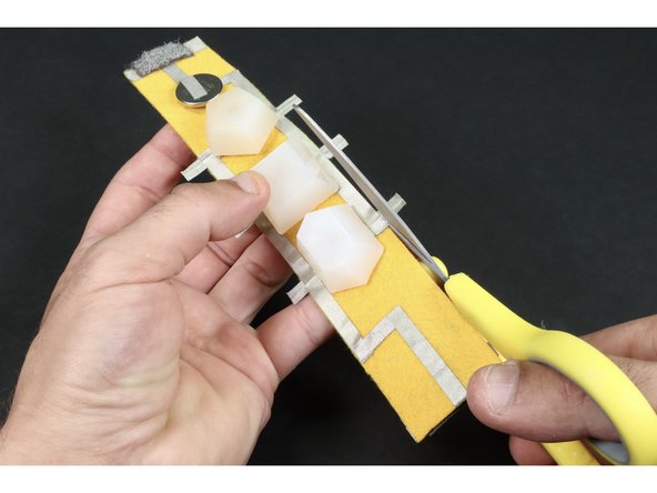 Use your scissors to trim the parts of the LED legs that hang off the edge of the bracelet.