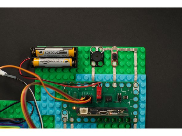 We'll first add a pushbutton and a piezo speaker as shown.