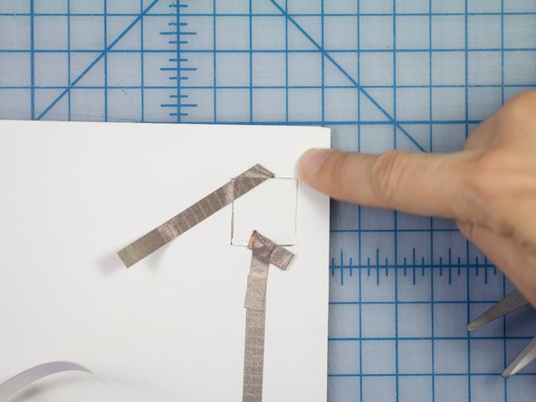 Direct the second piece toward the LED and adhere it to the poster board.