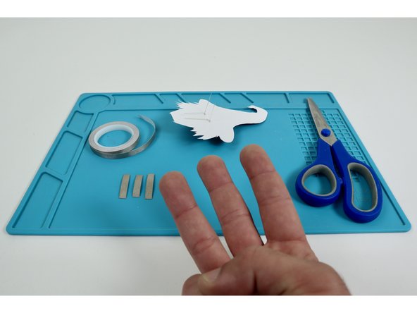 Measure and cut three pieces of Maker Tape that are approximately the length of the Long LED Legs.