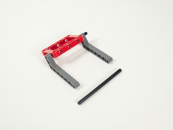 Add the other axle by sliding it into the first holes in the angled beams.