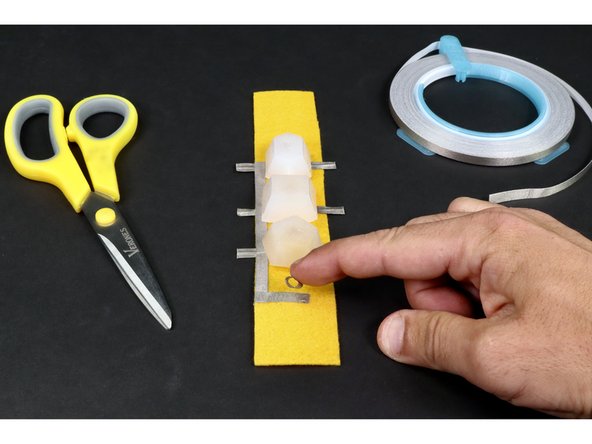 Stick the tape loop to the end of the small tape segment. If done correctly, your project should look like photo 3.
