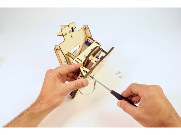 Insert this assembly into the remaining holes on the Solar Tracker base as pictured and secure by tightening the screws and nuts with your screwdriver as done in previous steps.