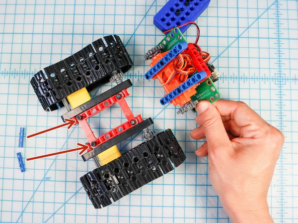 Separate the tank where the blue beams meet the red frame.