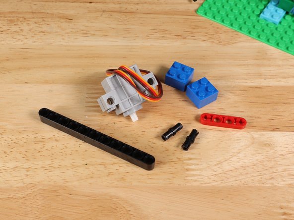 Insert two black pins on the side of the servo where the wires connect.