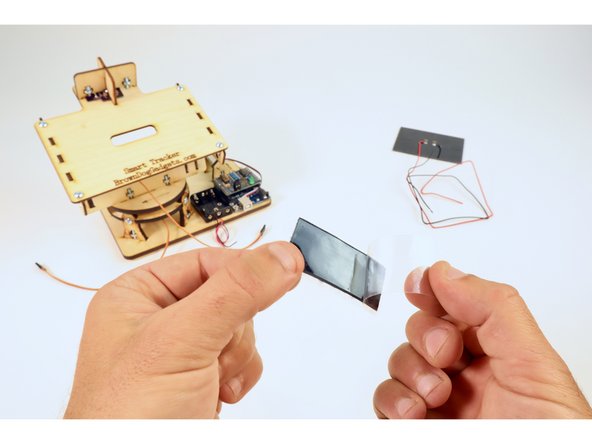 Find the Solar Panel and velcro strip in your kit and peel one side of the velcro backing off to reveal its sticky side.