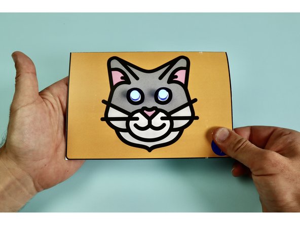 Your circuit is now finished. It will not turn on until or unless the card is closed and pinched where shown on the bottom right corner  of the front image. 