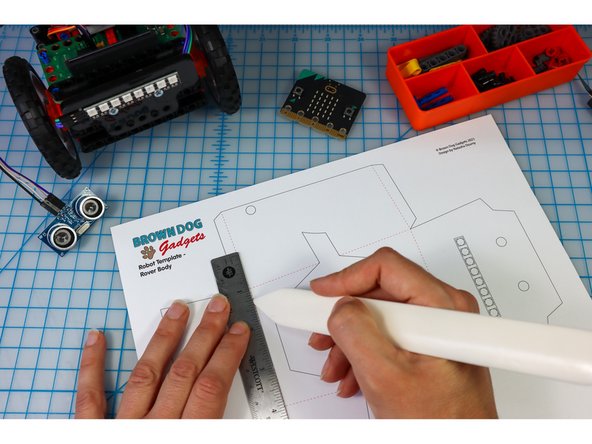 Use a bone folder or pen to score along the dotted lines to make it easier to fold later.