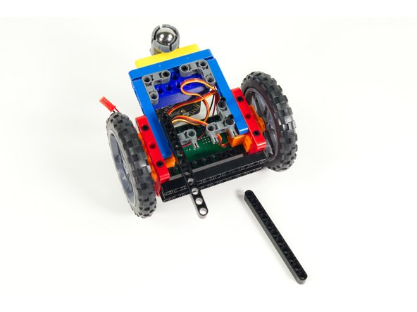 Add the black 11 beams to each set of of pins so the beams stick out the front of the Rover.