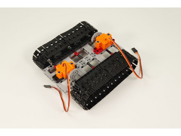 For each servo use 2 LEGO Long Pin with Friction parts to attach the servo as shown,