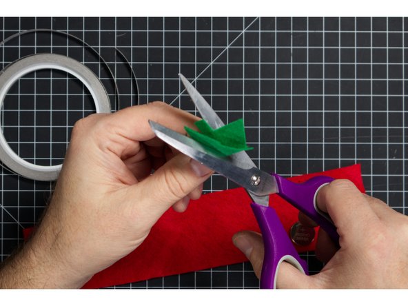 Cut out your Christmas Tree (or any shape you want) and cut a slit in the center just long enough to fit over the LED.