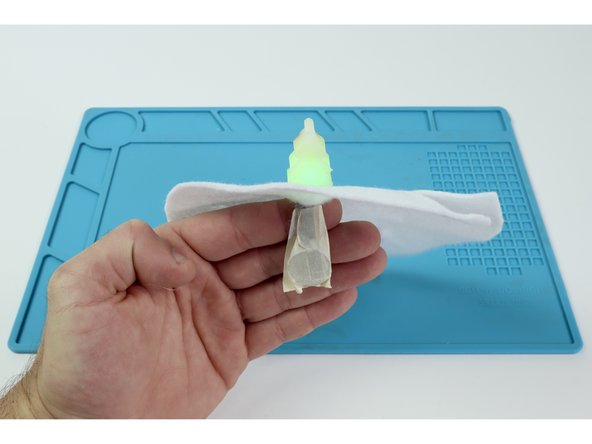 Once the felt is cut, plan out where you want to place each element. Use a pencil to draw a faint 2&quot; line on the felt where each stick will go and then cut slits with your scissors. A single slit from the edge will work for the craft tree if you made one.