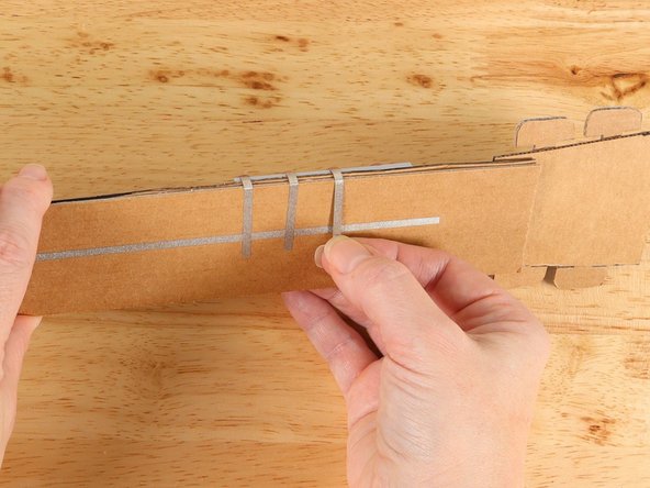 Wrap the tape around to the back of the neck and connect it to the ground pathway.