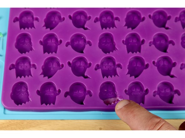 Now take your LEDs with legs bent and place them atop that glue one-by-one as shown, holding each in place for 30 seconds. This allows this small amount of glue to harden BELOW the bulb (actually the front of the FINISHED object) and holds the LED in place before final filling.