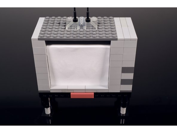 Add some tiles to seal the deal (we used some 2x2 90 degree plates with flat tiles on them) OR make the walls one layer shorter so there is no gap between the top of the TV build and the top of the shadowbox.