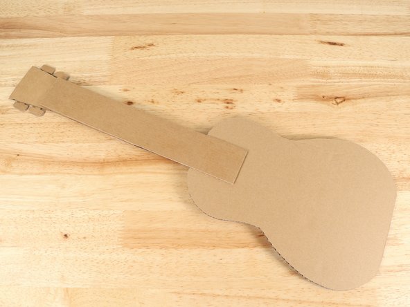 Flip the guitar over and glue the second neck to the back of the first neck. This will make the guitar stronger and more sturdy.