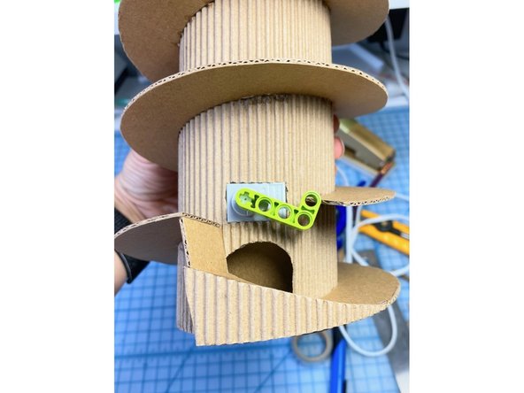 We created an extra piece that directs the gumball through the hole. We added the front triangle to this piece for decoration.