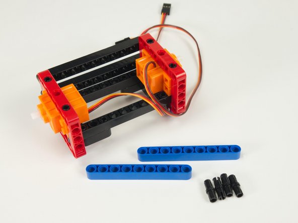 Now that we've got the main frame assembled, and the front beams in place, let's turn the rover around and upside down to work on the back side.