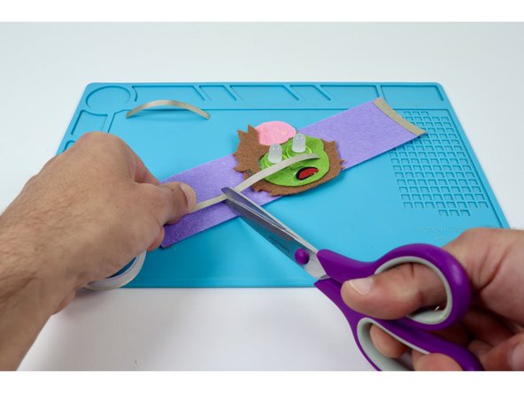 Measure and cut two Maker Tape paths that can reach from the furthest LED out to a point just past the edge of the felt embellishment.