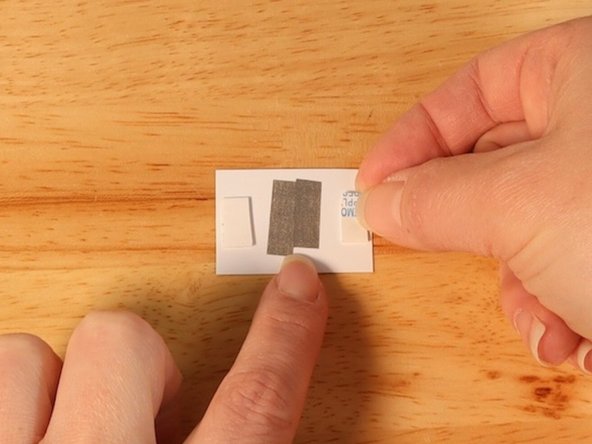 Add two pieces of double sided foam tape to each end of the &quot;SPIN!&quot; switch.