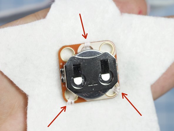 Use a needle and thread to tack the crazy circuits components in place as shown.