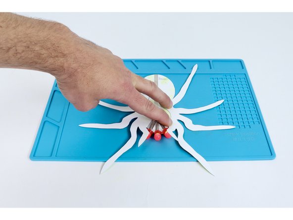 Press your last legs template into place as shown so the smallest legs are oriented toward the LEDs.