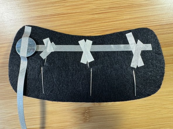 Fold the legs flat with the shorter, negative leg touching the top row of Maker Tape.