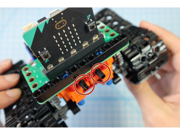 Add two black pins to the front as shown.