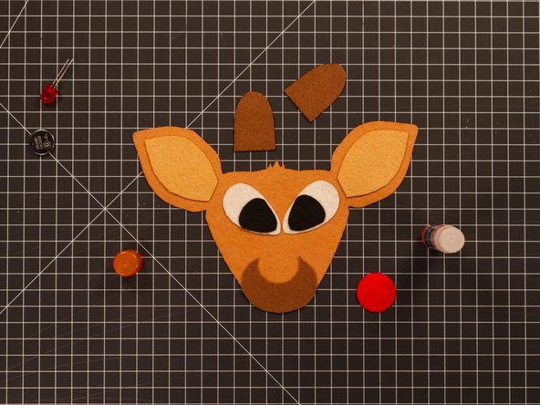 Glue the muzzle in place. It should line up with the bottom of the face.