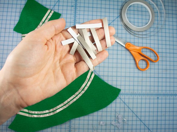 Cut many strips of maker tape about the length of the LED legs