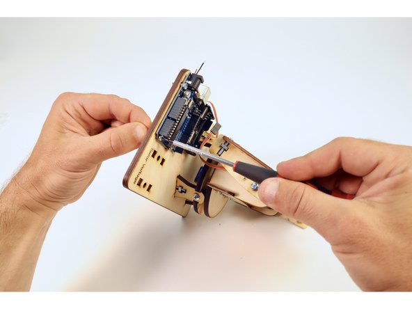 Secure the Arduino to the Solar Tracker assembly by tightening the four screws to the four nuts with your screwdriver.
