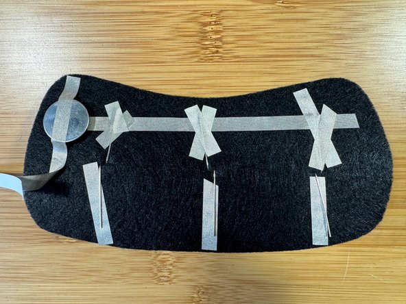 Fold the longer, positive legs down toward the bottom of the big piece.