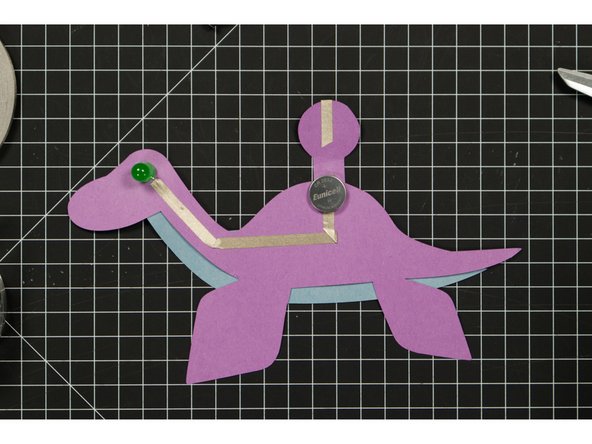 Place the battery so that bottom (negative) side is over the negative line of tape.