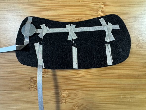 Then, twist it so that the adhesive is facing up instead of down. (photo 3)