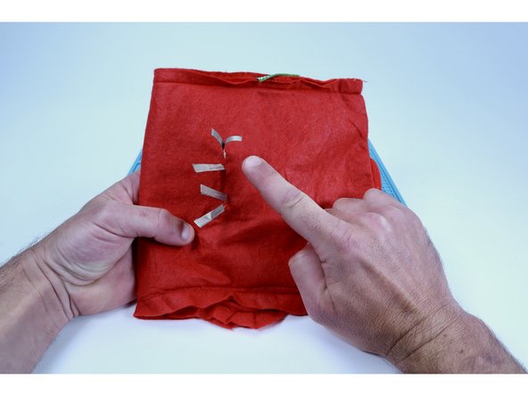 Turn your project inside out. Select two of your Maker Tape segments that you just cut. Peel and stick one of them to each of LED legs as shown in the second photo. Remember to note which ones are longer than the others.