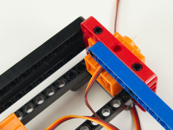 Make sure to lay the servo wire flat against the body of the servo and into the groove for the wire before attaching the blue beam.